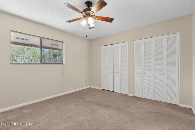 3801 Crown Point Rd Unit 1032, Jacksonville, FL 32257 - unfurnished bedroom featuring ceiling fan, visible vents, baseboards, carpet floors, and multiple closets