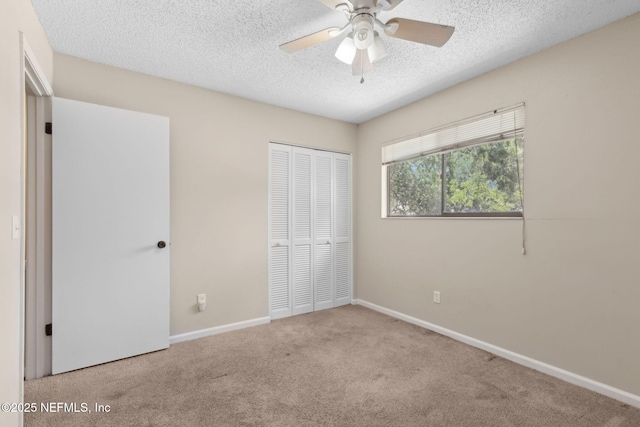 3801 Crown Point Rd Unit 1032, Jacksonville, FL 32257 - unfurnished bedroom featuring carpet floors, a closet, baseboards, ceiling fan, and a textured ceiling