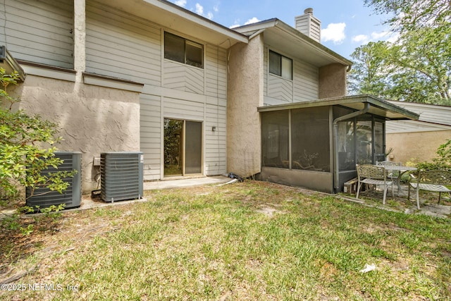 3801 Crown Point Rd Unit 1032, Jacksonville, FL 32257 - back of house with central air condition unit, a chimney, a sunroom, and stucco siding