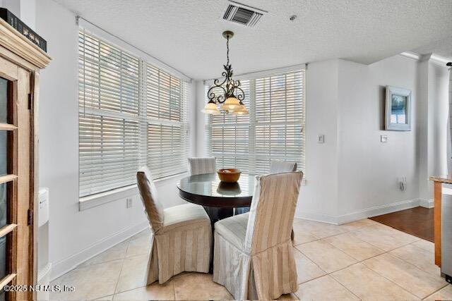230 N Serenata Dr Unit 711, Ponte Vedra Beach, FL 32082 - dining space featuring visible vents, plenty of natural light, light tile patterned flooring, and a chandelier