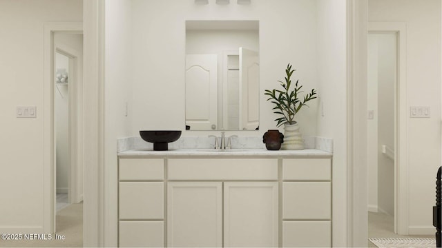 bathroom with vanity and baseboards