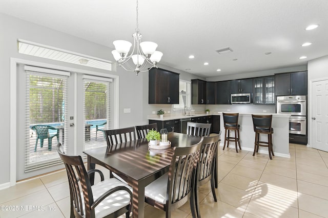 228 Gladstone Ct, Saint Johns, FL 32259 - dining area with light tile patterned flooring, a chandelier, recessed lighting, and baseboards