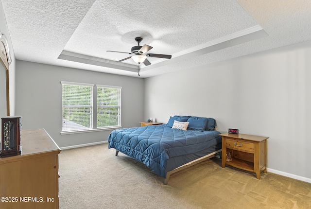228 Gladstone Ct, Saint Johns, FL 32259 - bedroom with a tray ceiling, a textured ceiling, light colored carpet, baseboards, and ceiling fan