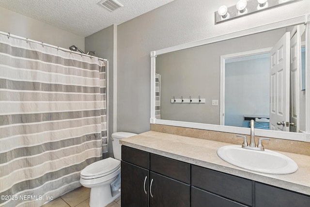 228 Gladstone Ct, Saint Johns, FL 32259 - full bath featuring toilet, vanity, a textured ceiling, and tile patterned floors