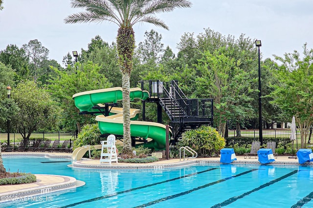 228 Gladstone Ct, Saint Johns, FL 32259 - community pool with a water slide, fence, and view of wooded area