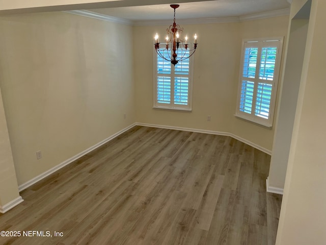 188 Irish Rose Rd, Saint Augustine, FL 32092 - unfurnished dining area with ornamental molding, a notable chandelier, baseboards, and wood finished floors