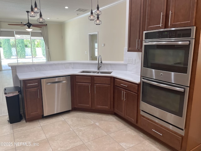 188 Irish Rose Rd, Saint Augustine, FL 32092 - kitchen with light countertops, visible vents, a sink, crown molding, and stainless steel appliances