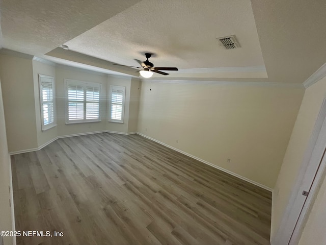 188 Irish Rose Rd, Saint Augustine, FL 32092 - unfurnished room featuring a textured ceiling, visible vents, crown molding, a raised ceiling, and baseboards