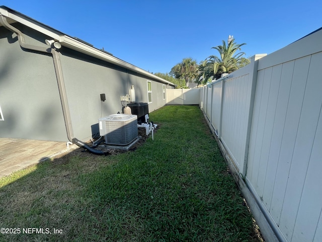 188 Irish Rose Rd, Saint Augustine, FL 32092 - view of property exterior with central AC unit, a lawn, and a fenced backyard
