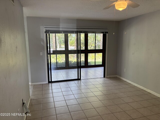 23 Salisbury Ct, Palm Coast, FL 32137 - spare room featuring a ceiling fan, a textured ceiling, and light tile patterned floors