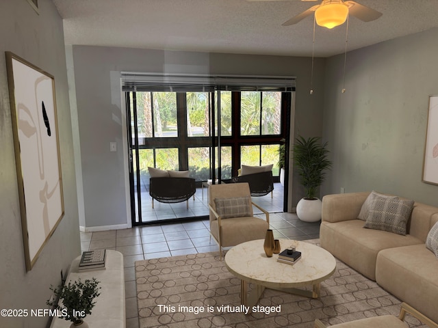 tiled living room with baseboards, a textured ceiling, ceiling fan, and a healthy amount of sunlight