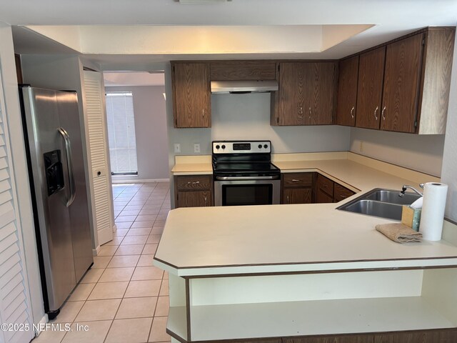 23 Salisbury Ct, Palm Coast, FL 32137 - kitchen featuring dark brown cabinets, light countertops, ventilation hood, appliances with stainless steel finishes, and light tile patterned floors
