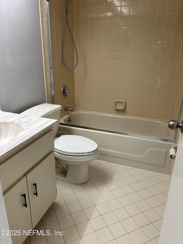bathroom featuring tile patterned floors, vanity, toilet, and tub / shower combination