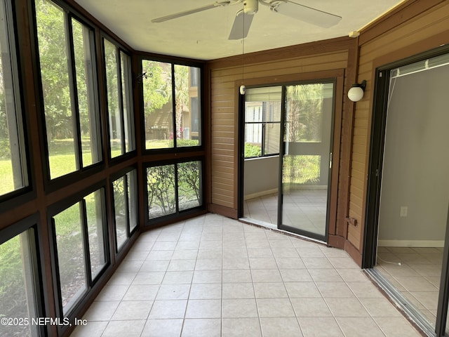 unfurnished sunroom with ceiling fan