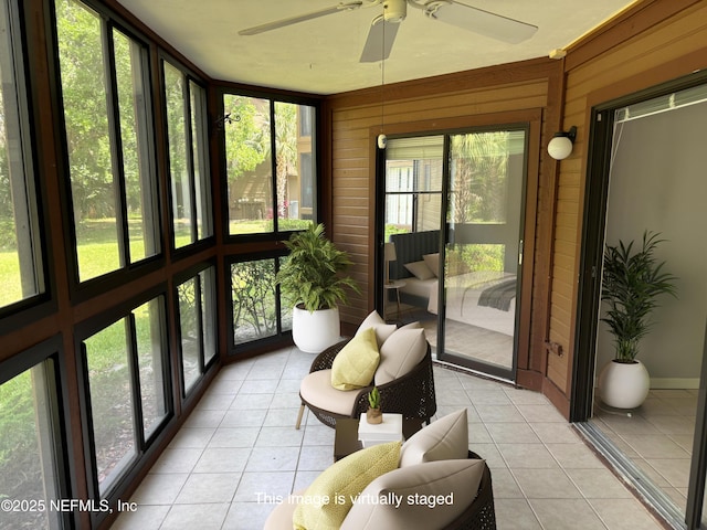 sunroom / solarium featuring ceiling fan
