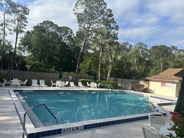 pool with fence and a patio area