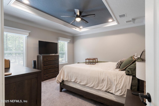 bedroom featuring visible vents, a raised ceiling, ornamental molding, light carpet, and recessed lighting