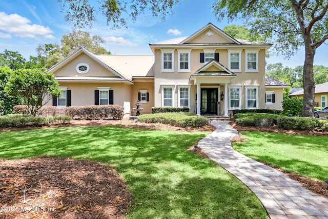 view of front of property featuring stucco siding and a front lawn