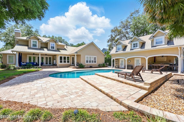 outdoor pool featuring ceiling fan, a patio, and french doors