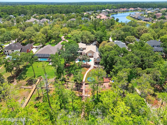 aerial view of residential area featuring a large body of water