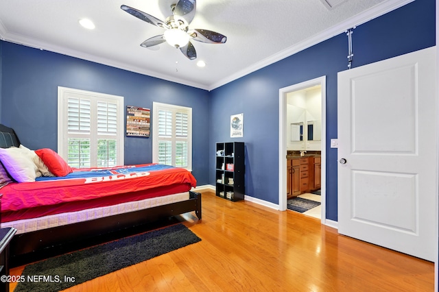 bedroom with crown molding, light wood finished floors, recessed lighting, ensuite bathroom, and baseboards