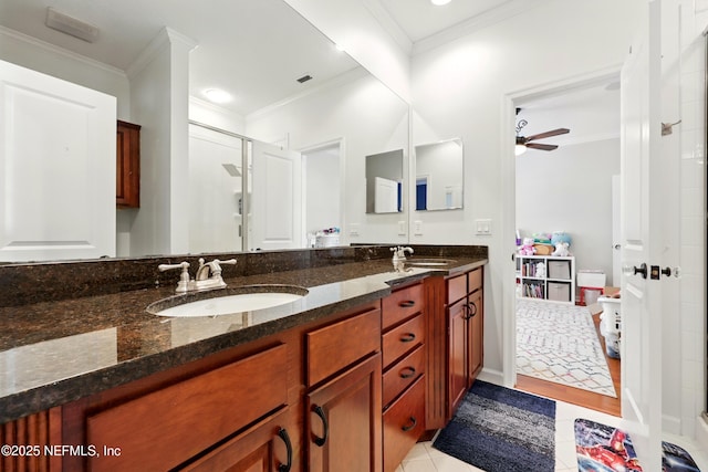 full bathroom featuring a stall shower, a ceiling fan, double vanity, crown molding, and tile patterned floors