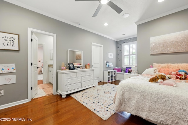 bedroom featuring crown molding, wood finished floors, recessed lighting, baseboards, and ensuite bathroom