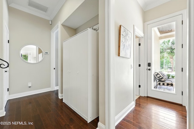 entryway featuring ornamental molding, dark wood-style flooring, and baseboards