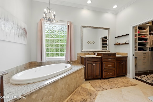 full bath with ornamental molding, vanity, tile patterned flooring, a walk in closet, and a chandelier
