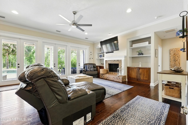living area with plenty of natural light, a ceiling fan, dark wood-style floors, crown molding, and french doors