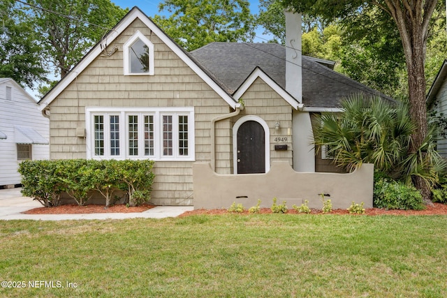 4949 Fremont St, Jacksonville, FL 32210 - bungalow-style house featuring a shingled roof and a front yard