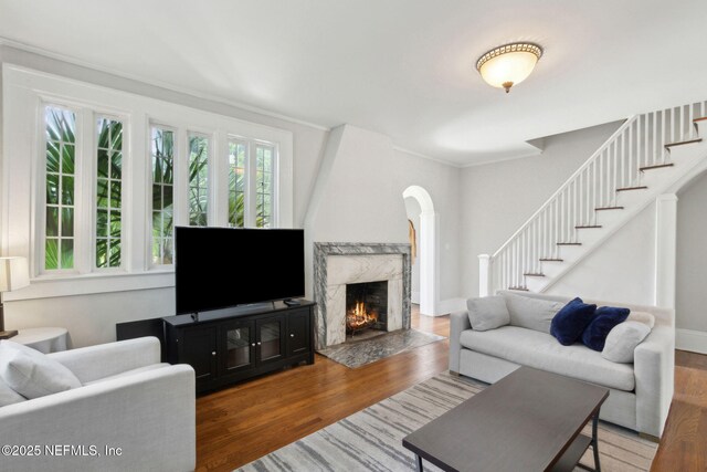 4949 Fremont St, Jacksonville, FL 32210 - living room featuring stairs, a premium fireplace, crown molding, and wood finished floors