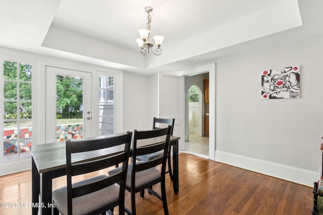 4949 Fremont St, Jacksonville, FL 32210 - dining area with baseboards, a tray ceiling, a notable chandelier, and a wealth of natural light