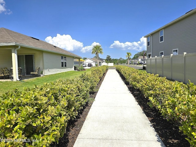 view of property's community featuring fence and a residential view