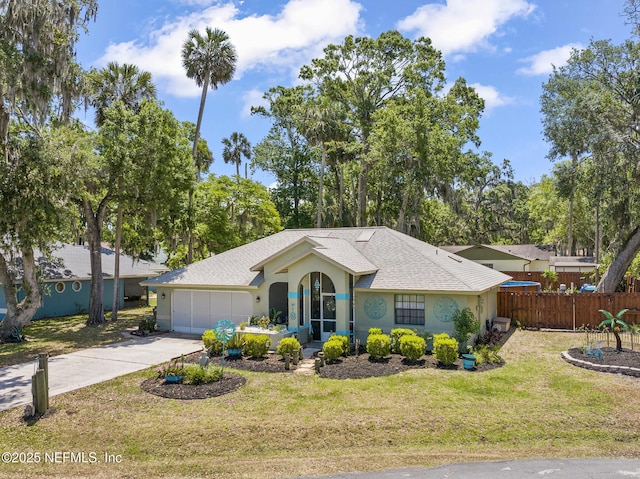 ranch-style house with a garage, fence, a front yard, stucco siding, and driveway