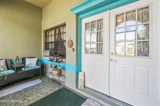 property entrance with stucco siding