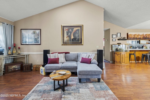 living area featuring wood finished floors and lofted ceiling