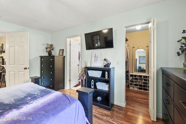 bedroom featuring baseboards and wood finished floors