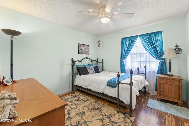 bedroom featuring wood-type flooring, a ceiling fan, and a textured ceiling