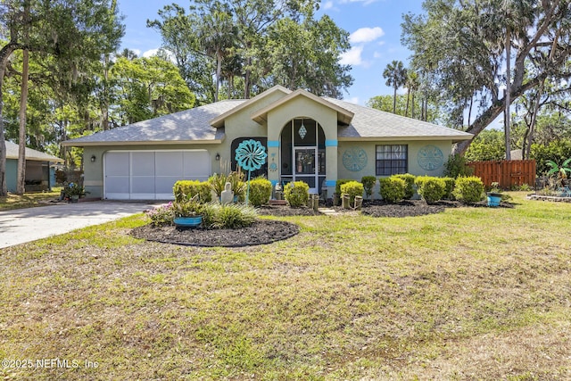 ranch-style home with fence, a front lawn, a garage, stucco siding, and driveway