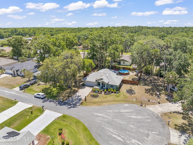 birds eye view of property with a forest view