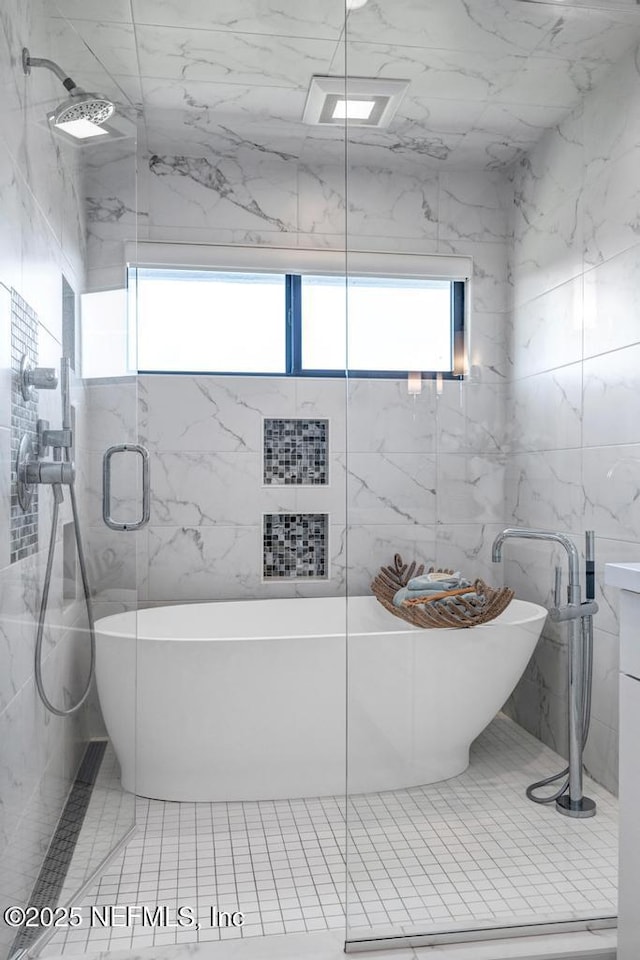 2325 Seminole Rd, Atlantic Beach, FL 32233 - full bath featuring tile walls, a freestanding bath, and a stall shower