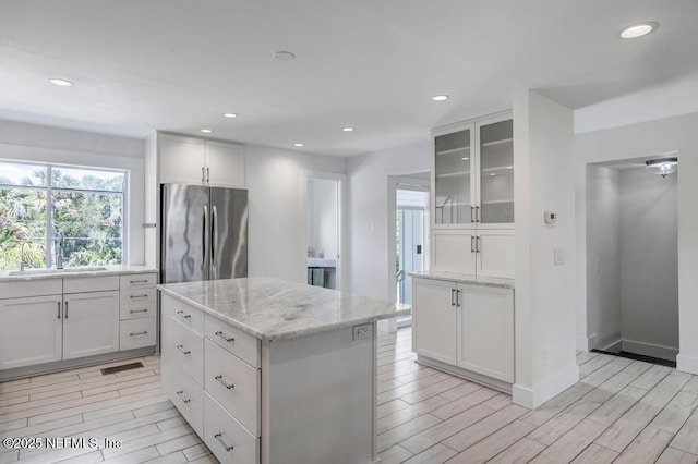 2325 Seminole Rd, Atlantic Beach, FL 32233 - kitchen with freestanding refrigerator, a sink, wood finish floors, and a wealth of natural light