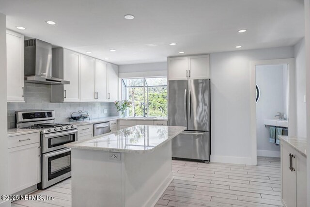 2325 Seminole Rd, Atlantic Beach, FL 32233 - kitchen with wall chimney range hood, backsplash, light stone countertops, a sink, and stainless steel appliances