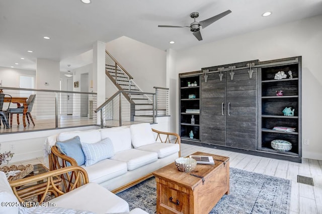 2325 Seminole Rd, Atlantic Beach, FL 32233 - living room with recessed lighting, ceiling fan, wood finished floors, and stairway