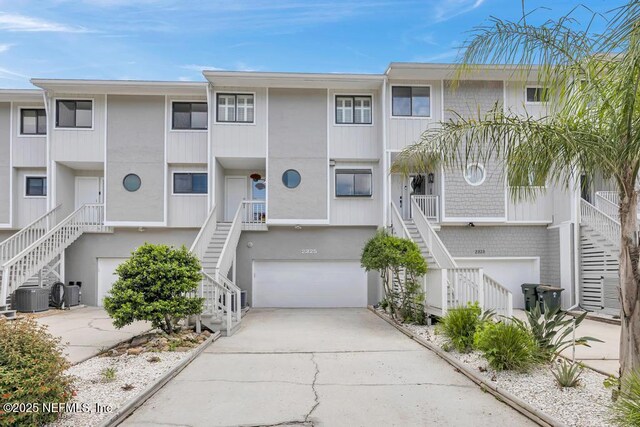 2325 Seminole Rd, Atlantic Beach, FL 32233 - view of property featuring central air condition unit, stairs, and a garage
