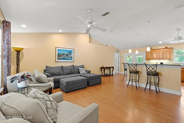 living area featuring ceiling fan, light wood-type flooring, recessed lighting, lofted ceiling, and baseboards
