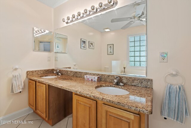 bathroom featuring tile patterned floors, double vanity, ceiling fan, and baseboards