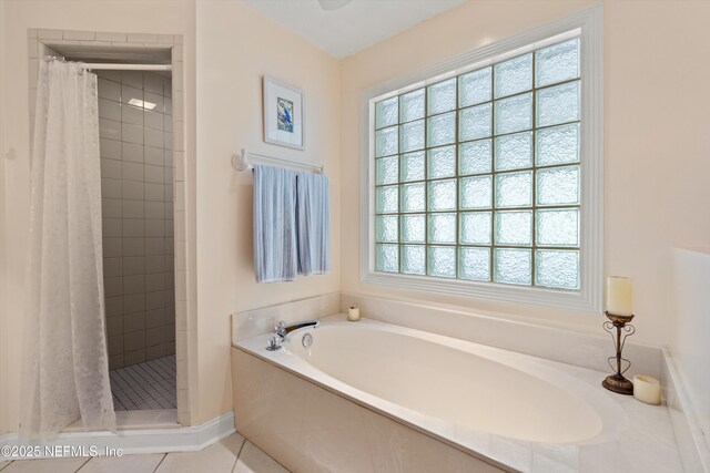 full bathroom with a shower stall, a garden tub, and tile patterned flooring