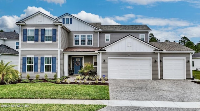 462 Hillendale Cir, Saint Johns, FL 32259 - view of front of property featuring board and batten siding, decorative driveway, an attached garage, and a front yard